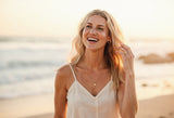 Brittany Ford laughing on the beach at golden hour